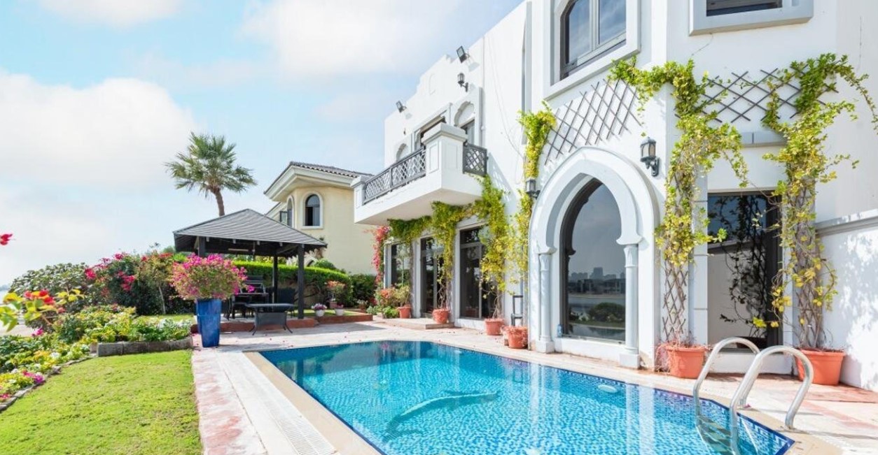 Private pool in a white villa with garden